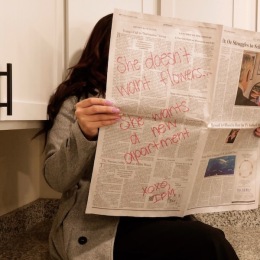 a woman reading a newspaper