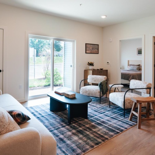 a living room with a couch, coffee table and chairs