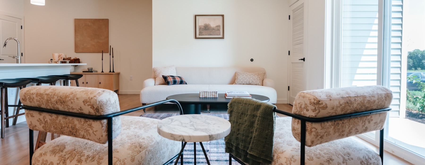 a living room with a couch and chairs