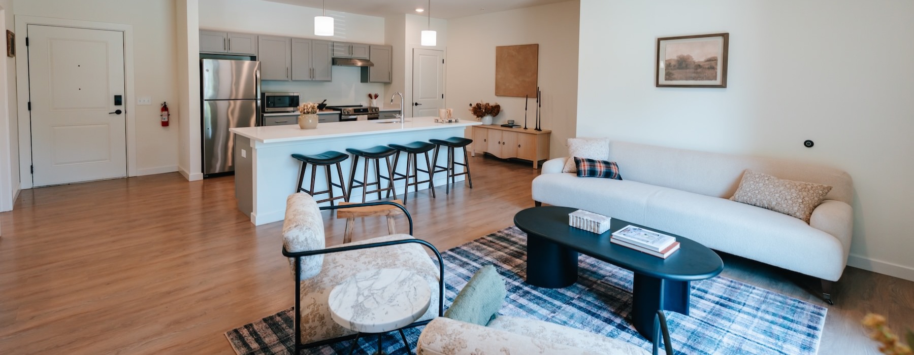 a living room with a couch, chairs and a coffee table