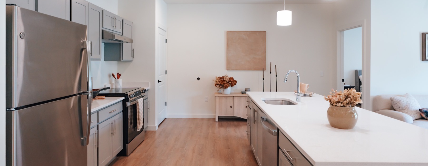 a kitchen with a refrigerator and a stove