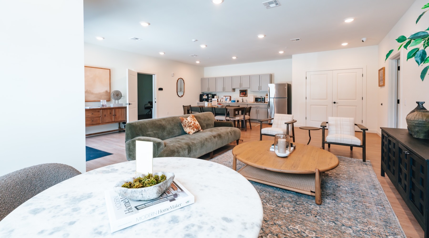 a clubroom with a couch, tables and chairs