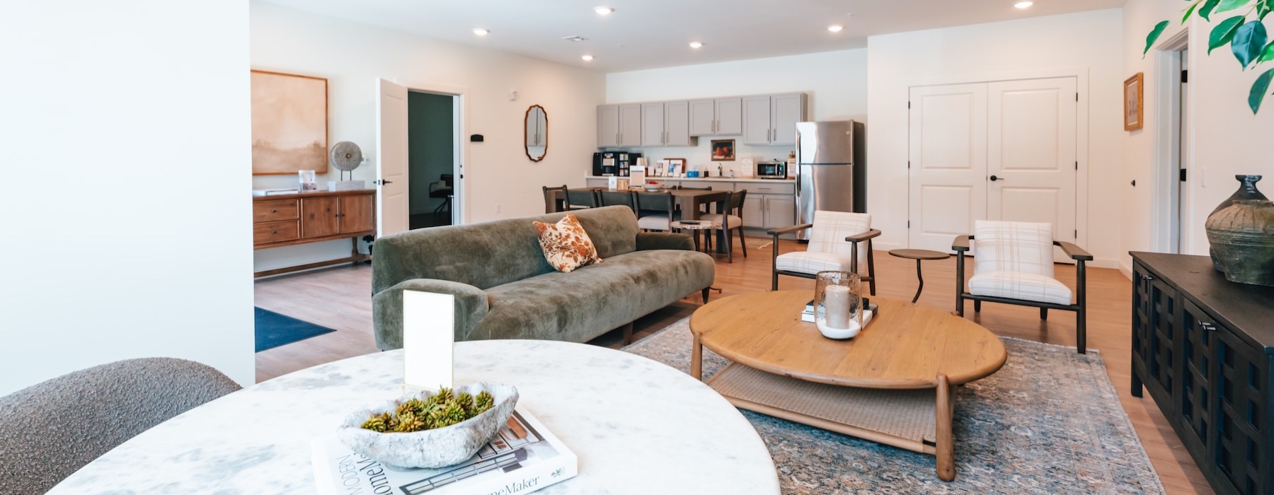 a clubroom with a couch, tables and chairs