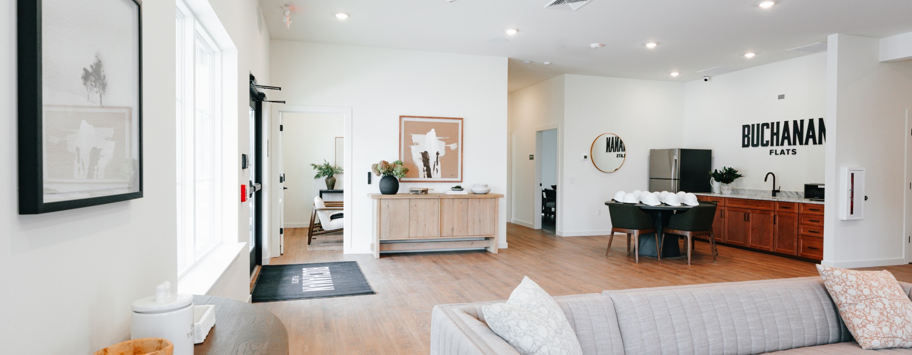 a clubroom with a couch, tables and chairs