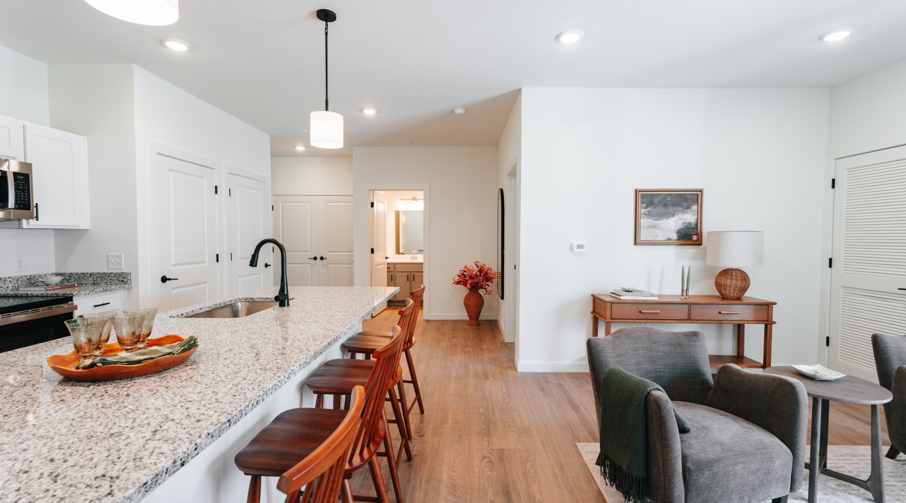 Kitchen and living room with a couch, coffee table and chairs