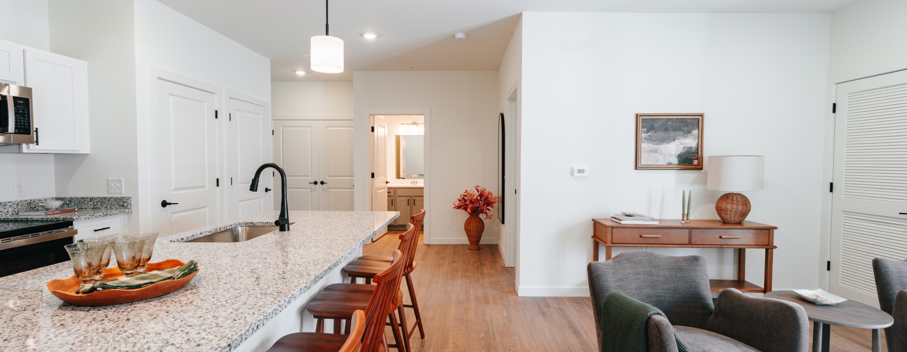 Kitchen and  living room with a couch, coffee table and chairs